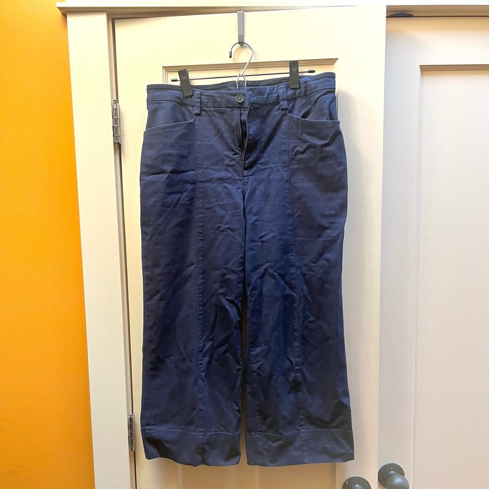 Cropped, wide-legged, navy trousers.